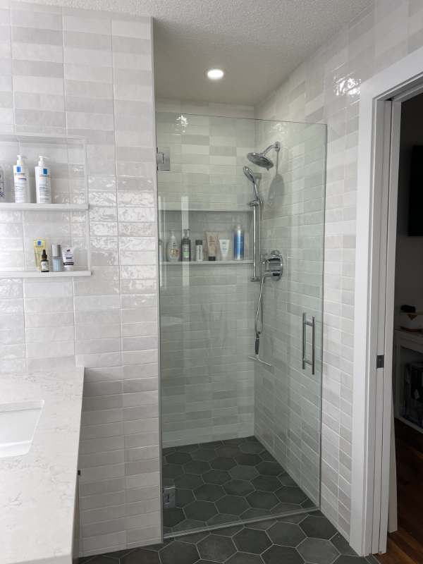 custom shower custom niche, custom glass, tileable trough drain. and beautiful tile